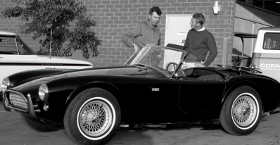 Carroll Shelby (left) and Steve McQueen discuss the Cobra.