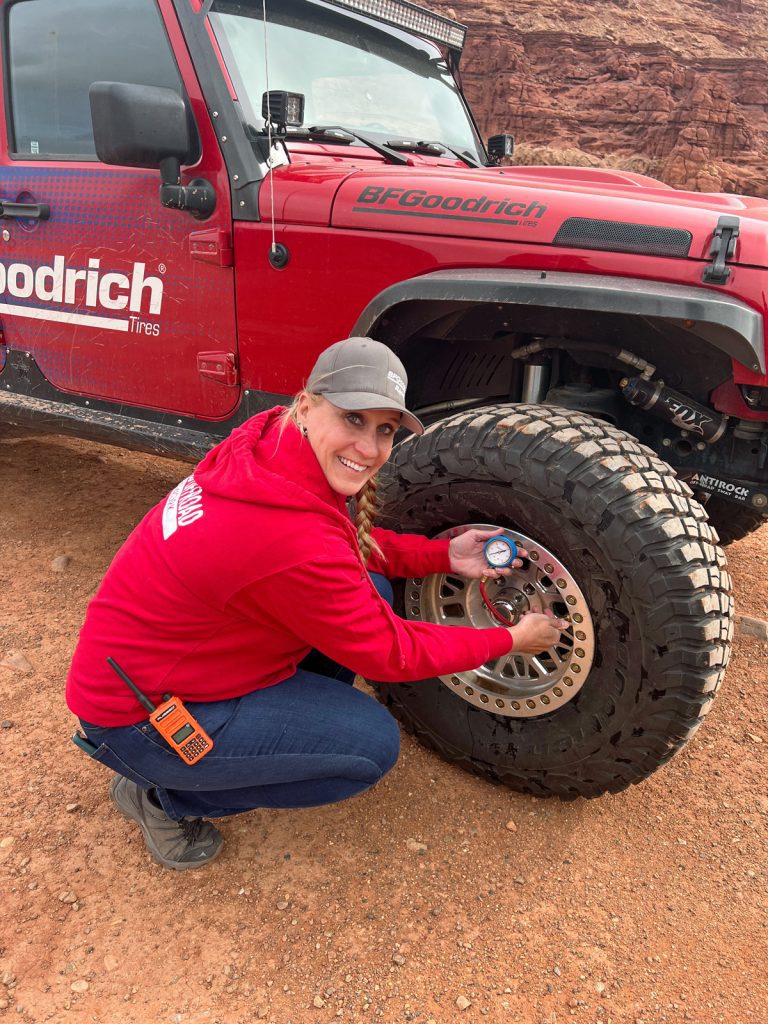 Charlene Bower airing down a BFGoodrich tire-the traditional way!