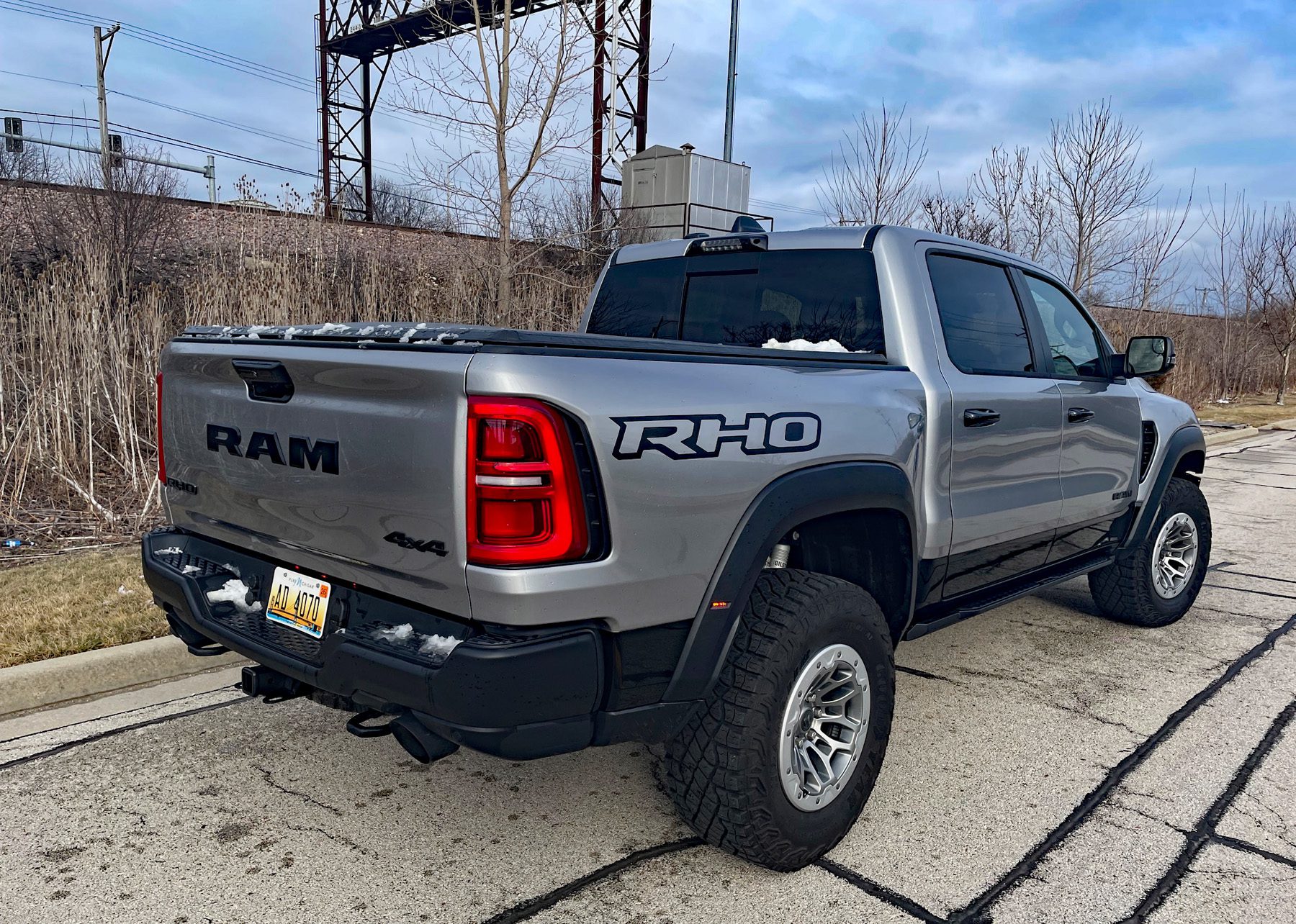 Rear 3/4, 2025 Ram 1500 RHO, railroad tracks, snow