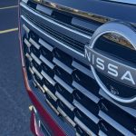 2025 Nissan Armada Platinum Reserve in Coulis Red, grille detail