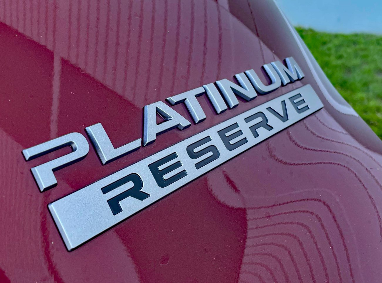 2025 Nissan Armada Platinum Reserve in Coulis Red, badge, What are trim levels?