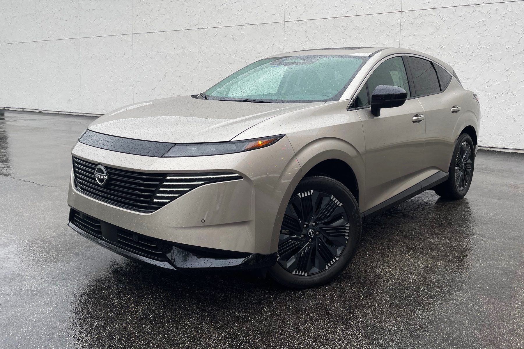 2025 Nissan Murano Platinum in Champagne Silver, front 3/4 view, rain,