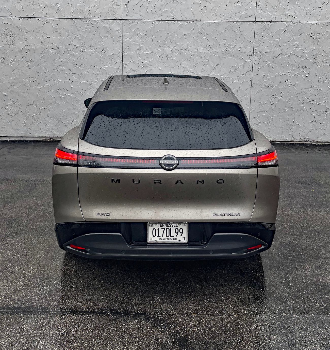2025 Nissan Murano Platinum in Champagne Silver, rear view, taillights on, rain,