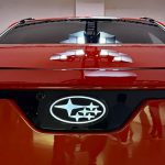 2026 Subaru Uncharted EV, Orange, grille detail, Subaru badge