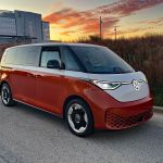 2025 Volkswagen ID. Buzz, Energetic Orange, front 3/4 view, sunset, magic hour,