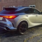 2025 Lexus RX 500h F Sport Performance in Iridium, rear 3/4 view, at night, taillights on,