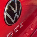 2025 Volkswagen Golf GTI SE in Kings Red, rear-hatch VW badge,