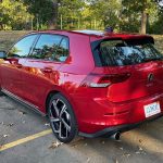 2025 Volkswagen Golf GTI SE in Kings Red, rear 3/4 view, rear view,