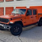 2025 Jeep Gladiator High Tide in Joose, front 3/4 view, orange, black wheels,