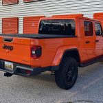 2025 Jeep Gladiator High Tide in Joose, rear 3/4 view, Orange Jeep,