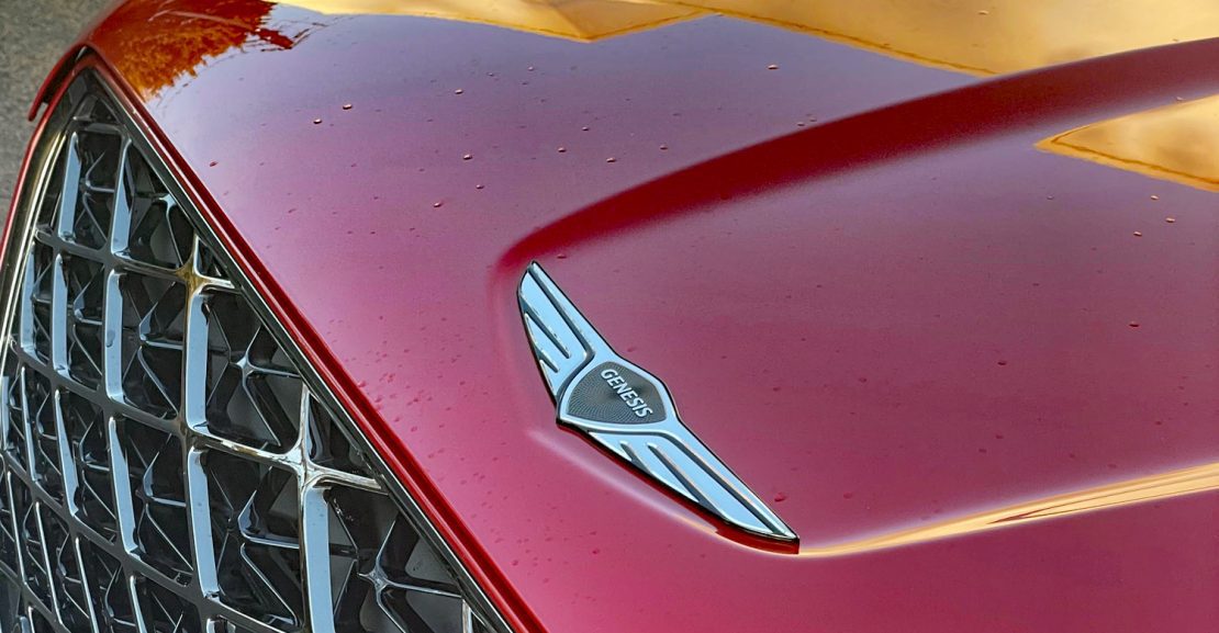 2026 Genesis GV70 Sport Prestige in Mauna Red, grille detail,