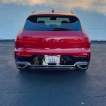 2026 Genesis GV70 Sport Prestige in Mauna Red, rear view,