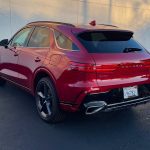 2026 Genesis GV70 Sport Prestige in Mauna Red, rear 3/4 view,