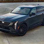 2026 Cadillac Escalade IQ Sport in Deep Space Metallic, front 3/4 view