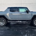 2026 GMC Hummer Pickup in Meteorite Metallic, profile, lights on,