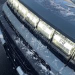 2026 GMC Hummer Pickup in Meteorite Metallic, grille light detail, lights on,