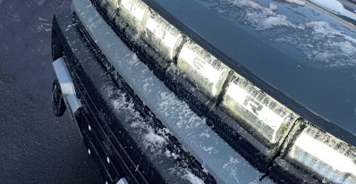 2026 GMC Hummer Pickup in Meteorite Metallic, grille light detail, lights on,