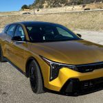 2026 Kia K4 Hatchback in Sparkling Yellow, front 3/4 view, sunny,