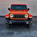 2025 Jeep Wrangler Sahara in Joose, front view, headlamps on,