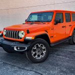 2025 Jeep Wrangler Sahara in Joose, front 3/4 view, orange,