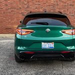 2025 Alfa Romeo Stelvio Intensa in Verde Fangio, rear view, lights on, taillights,