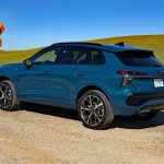 2026 Audi Q3 in Malpelo Blue metallic, rear 3/4 view, dfirt road,