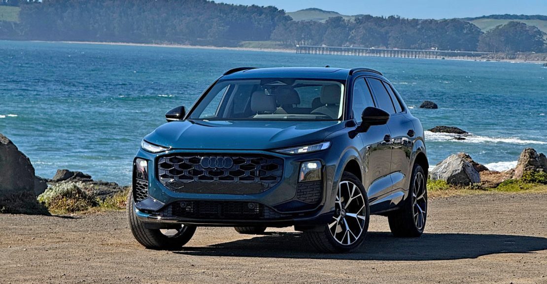 2026 Audi Q3 in Malpelo Blue, on beach, front 3/4 view,