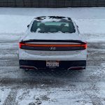 2026 Hyundai Sonata Hybrid Limited in Serenity White, rear view, taillights on, snow