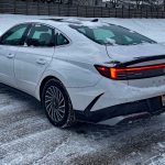 2026 Hyundai Sonata Hybrid Limited in Serenity White, rear 3/4 view, snow,