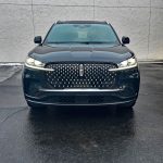 2026 Lincoln Aviator Black Label in Cenote Green, front end, headlights on,