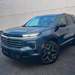 2026 Chevrolet Traverse High Country in Lakeshore Blue, front 3/4 view, headlights on,