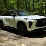 2027 Infiniti QX65, front 3/4 view, woods,