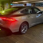 2026 Nissan Sentra SL in Imperial Bronze, rear 3/4 view, taillights on,
