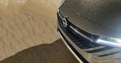 2026 Nissan Sentra SL in Imperial Bronze, front clip, wet, rain, grille detail,