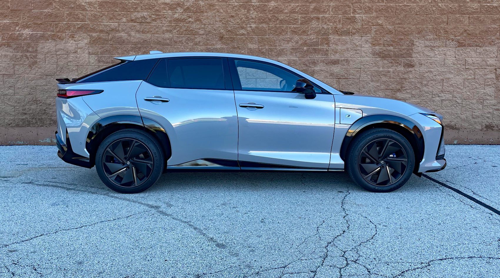 2026 Lexus RZ 500e F Sport in Wind, profile, brick wall, blue car,
