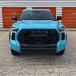2026 Toyota Tundra TRD Pro in Wave maker with TRD Performance Package, front end, blue, headlights on,