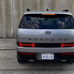 2026 Hyundai Santa Fe Hybrid Calligraphy in Shimmering Silver, rear view, taillights on,