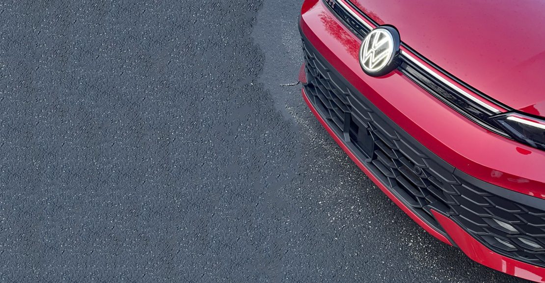 2026 Volkswagen GTI Autobahn in Kings Red, grille detail, VW Badge,