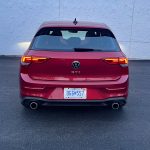 2026 Volkswagen GTI Autobahn in Kings Red, rear view, taillights on,