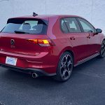 2026 Volkswagen GTI Autobahn in Kings Red, rear 3/4 view,