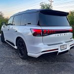 2026 Infiniti QX80 in Radiant White, rear 3/4 view, taillights,