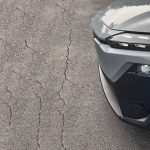 2026 Subaru Uncharted Sport in Metropolis Gray, Grille detail, headlights on, pavement, parking lot