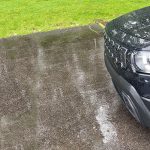 2026 Jeep Cherokee Laredo in Diamond Black Crystal, front clip, rain, headlights on,