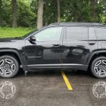 2026 Jeep Cherokee Laredo in Diamond Black Crystal, profile view, trees, rain,
