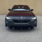 2025 BMW M5 Touring in Frozen Deep Grey, front end, headlights on,