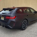 2025 BMW M5 Touring in Frozen Deep Grey, rear 3/4 view