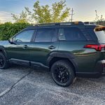 Rear 3/4 view, green, magic hour, 2026 Subaru Outback Wilderness in Deep Emerald Green Pearl