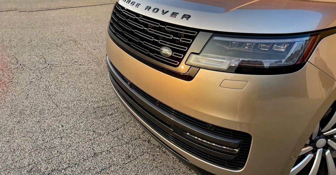 2026 Land Rover Range Rover SE in BatumiGold, grille detail, sunset, magic hour,