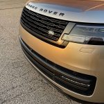 2026 Land Rover Range Rover SE in BatumiGold, grille detail, sunset, magic hour,