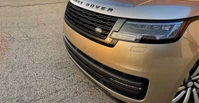 2026 Land Rover Range Rover SE in BatumiGold, grille detail, sunset, magic hour,